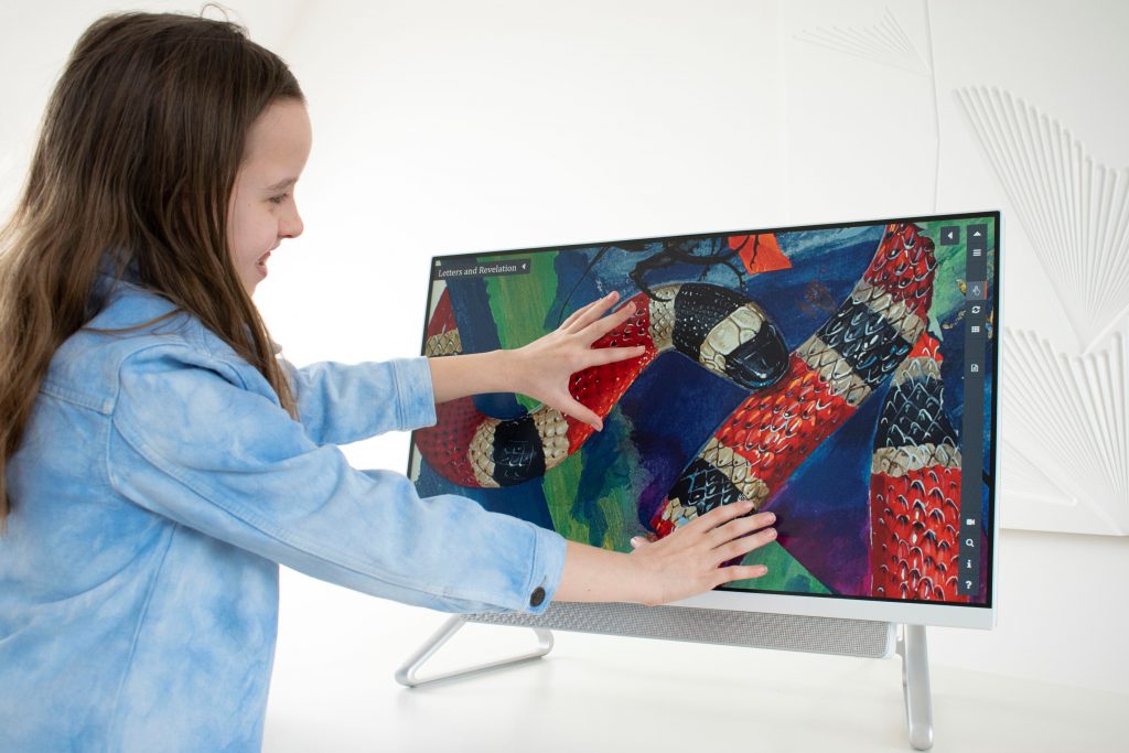 Young girl using Turning the Pages to zoom in on part of a page